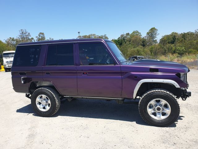 A purple suv is parked in a parking lot