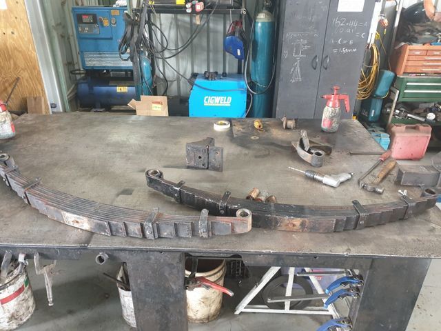 A piece of metal is sitting on a table in a garage.