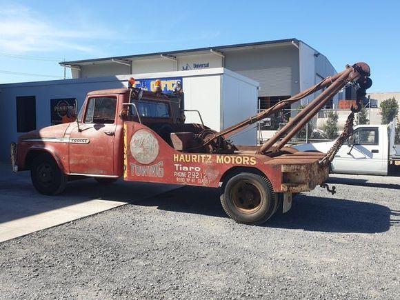 A dump truck is parked next to a cleanaway tank