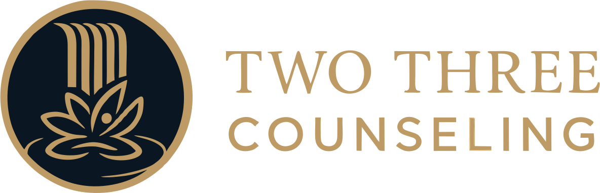 Logo for Two Three Counseling, featuring a blue circular design with a lotus flower and waterfall, with gold text.