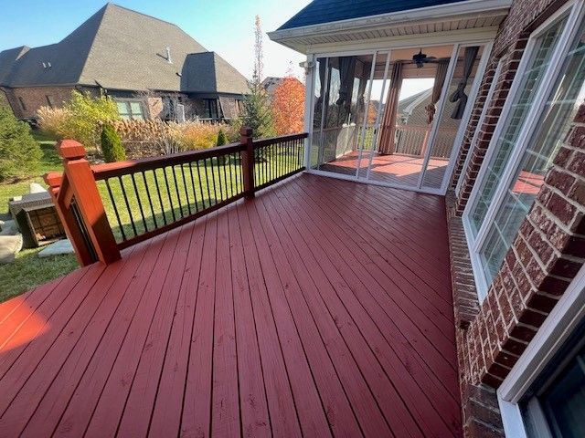 A Red Deck with A Railing and A Brick House in The Background - Bourbon City Softwash - Louisville, KY
