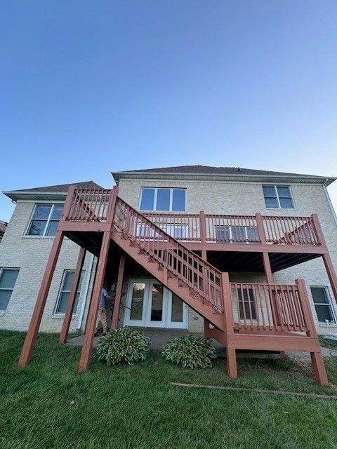 The back of a house with a wooden deck and stairs - Bourbon City Softwash - Louisville, KY