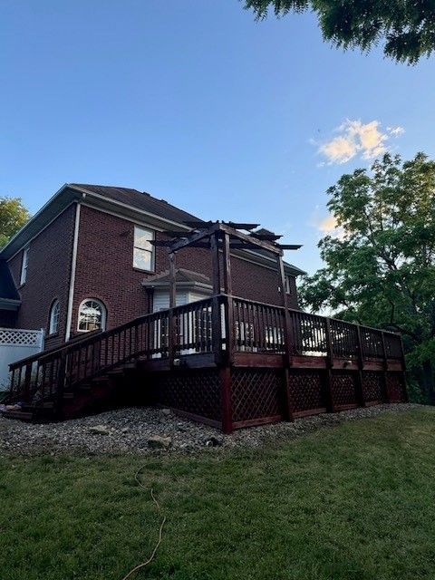 A large brick house with a large deck in front of it. - Bourbon City Softwash - Louisville, KY