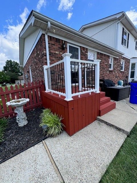 A house with a red deck and a white railing - Bourbon City Softwash - Louisville, KY