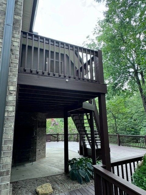 A wooden deck with stairs leading up to it - Bourbon City Softwash - Louisville, KY