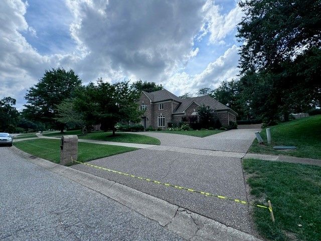 A Car Is Parked in Front of A Large House - Bourbon City Softwash - Louisville, KY