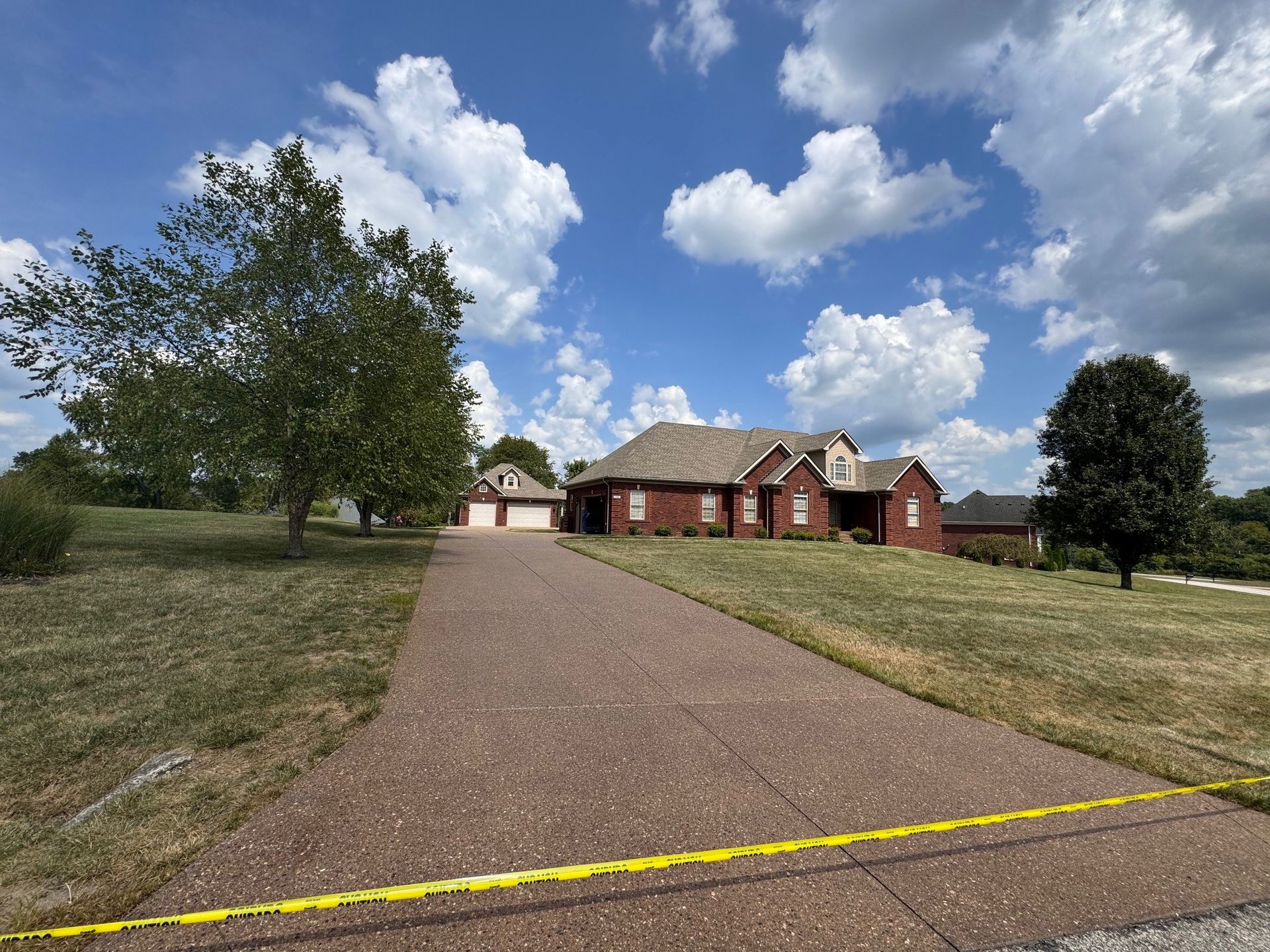A Large Red House Is Sitting on Top of A Grassy Hill. - Bourbon City Softwash - Louisville, KY