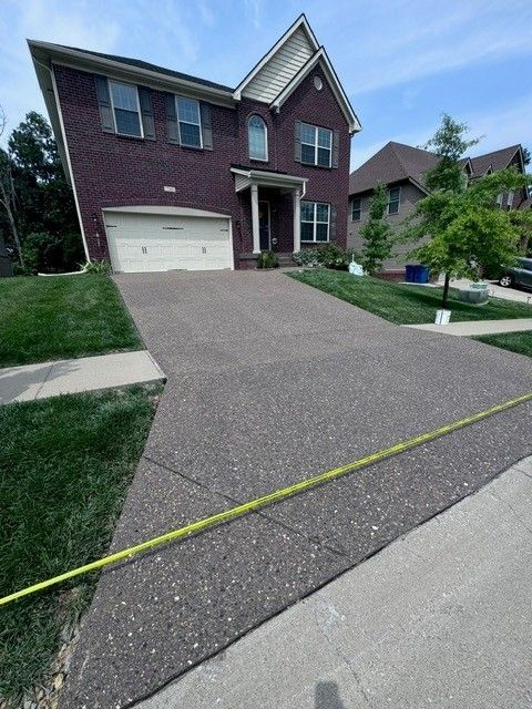 A Large Brick House with A Concrete Driveway in Front of It - Bourbon City Softwash - Louisville, KY