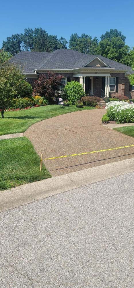 A house with a driveway and a brick driveway in front of it. - Bourbon City Softwash - Louisville, KY