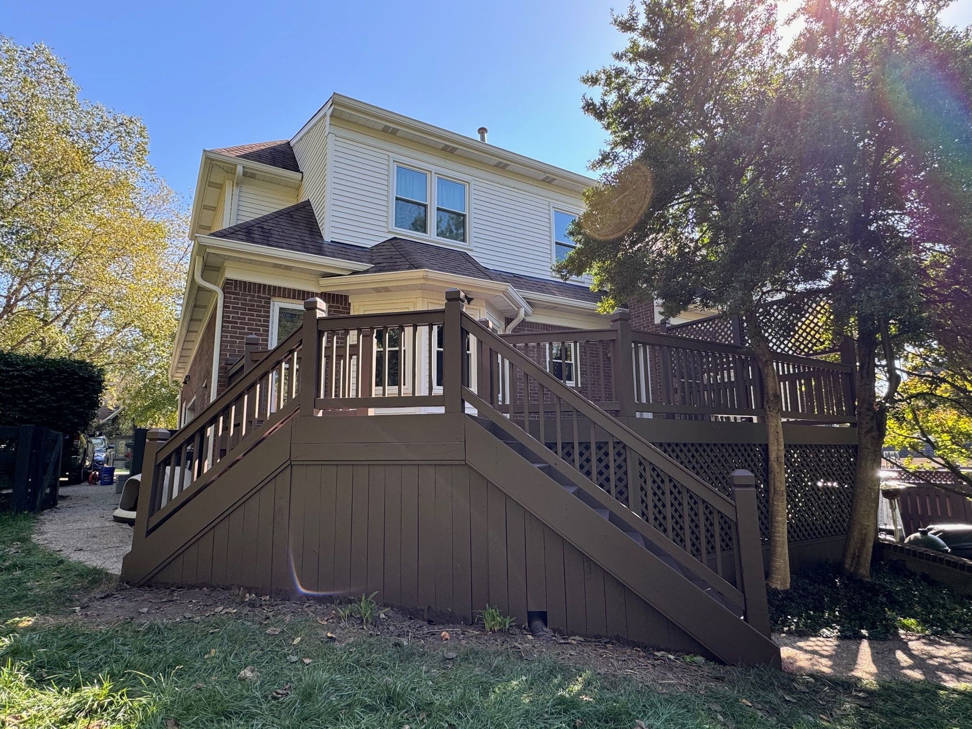 A large house with a large deck and stairs leading up to it.