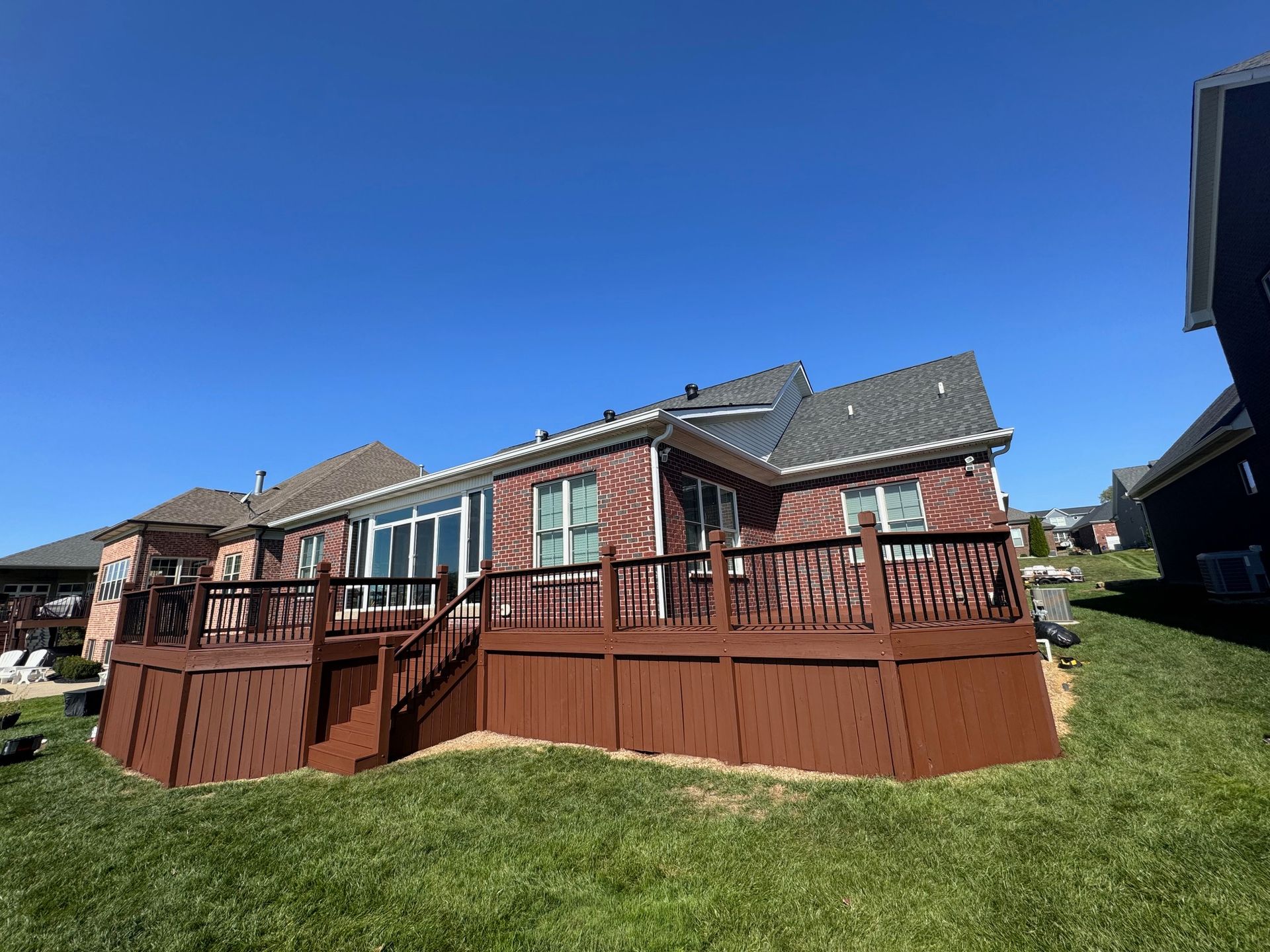 The Back of A House with A Large Deck and Stairs.
