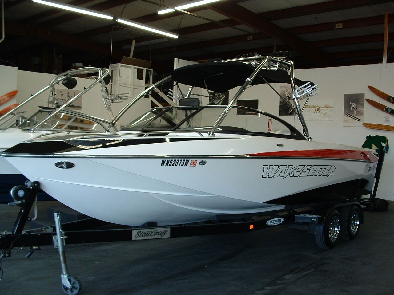 A white boat with a license plate that says 'nc' on it