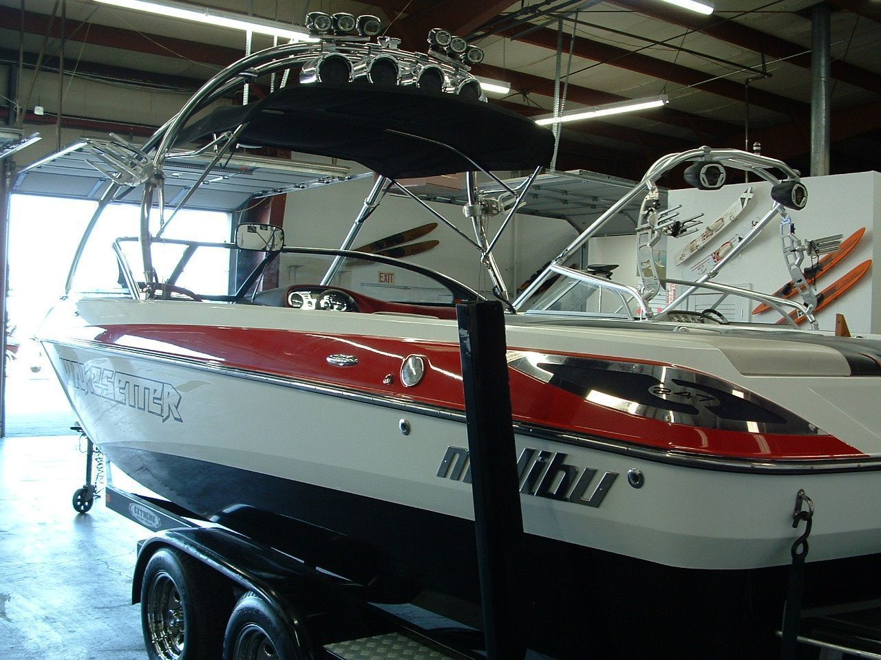 A red white and black malibu boat on a trailer