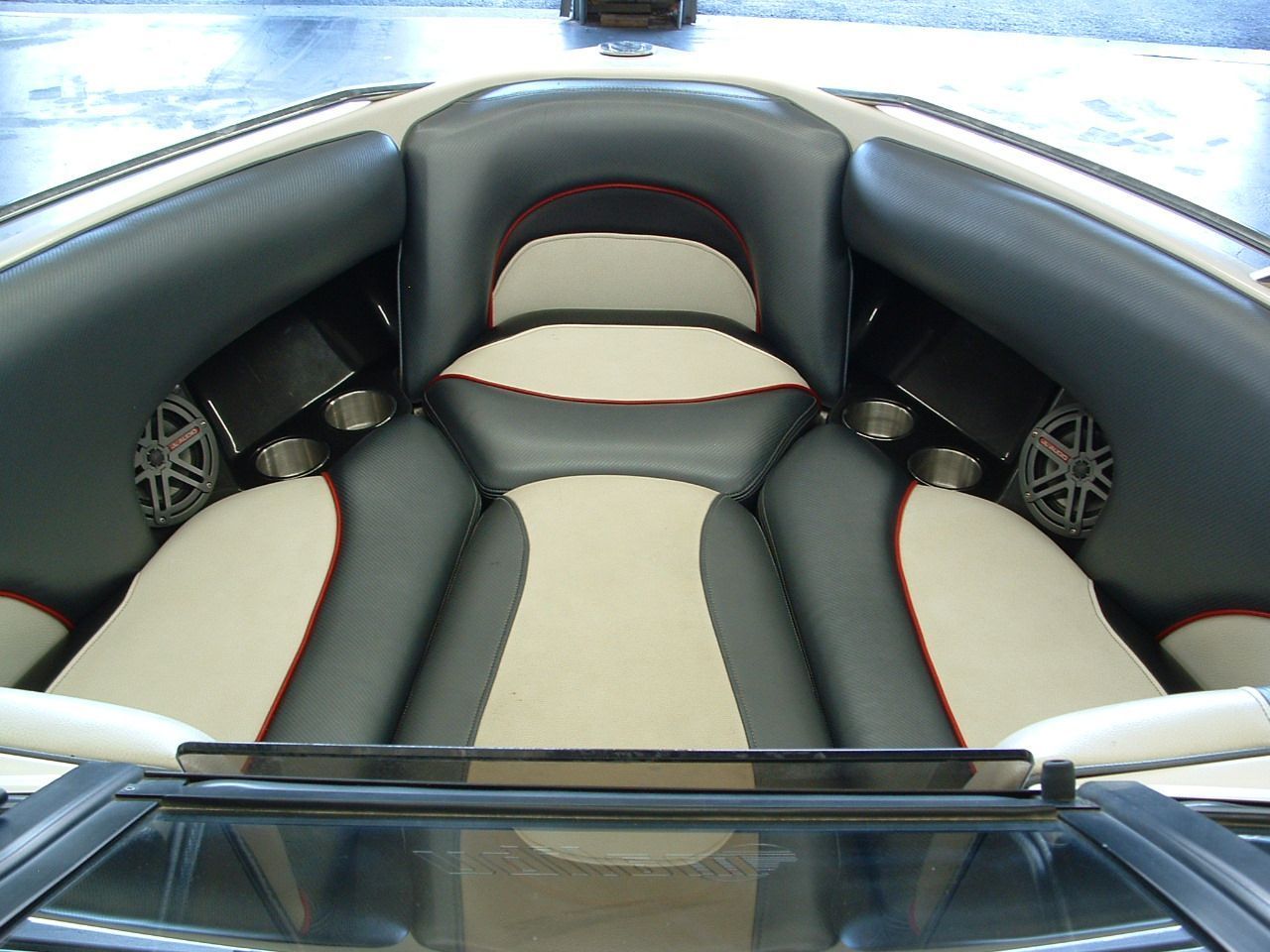 The inside of a boat with speakers on the seats