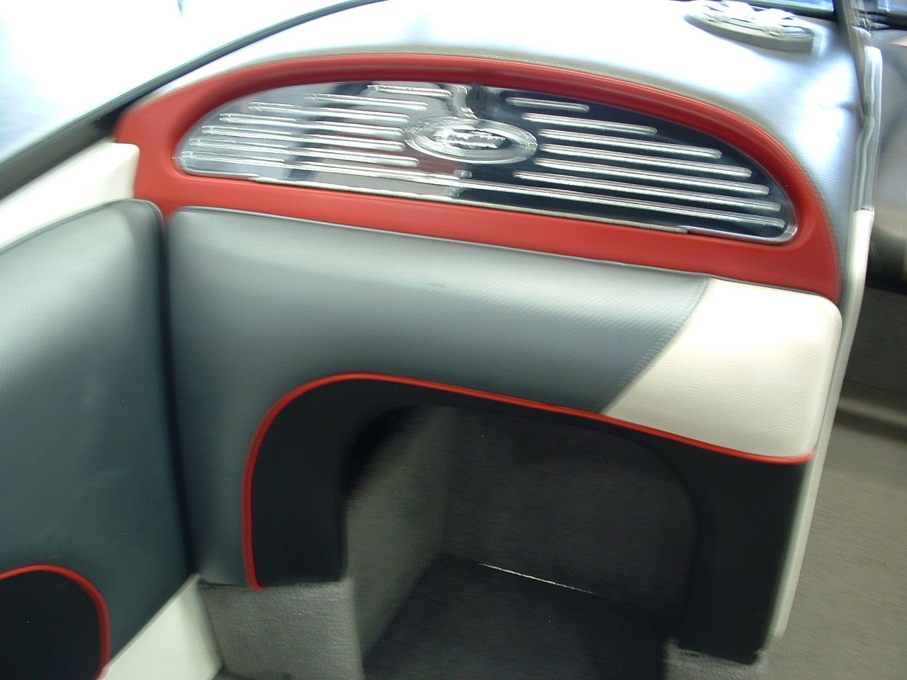 A close up of a boat seat with a red trim