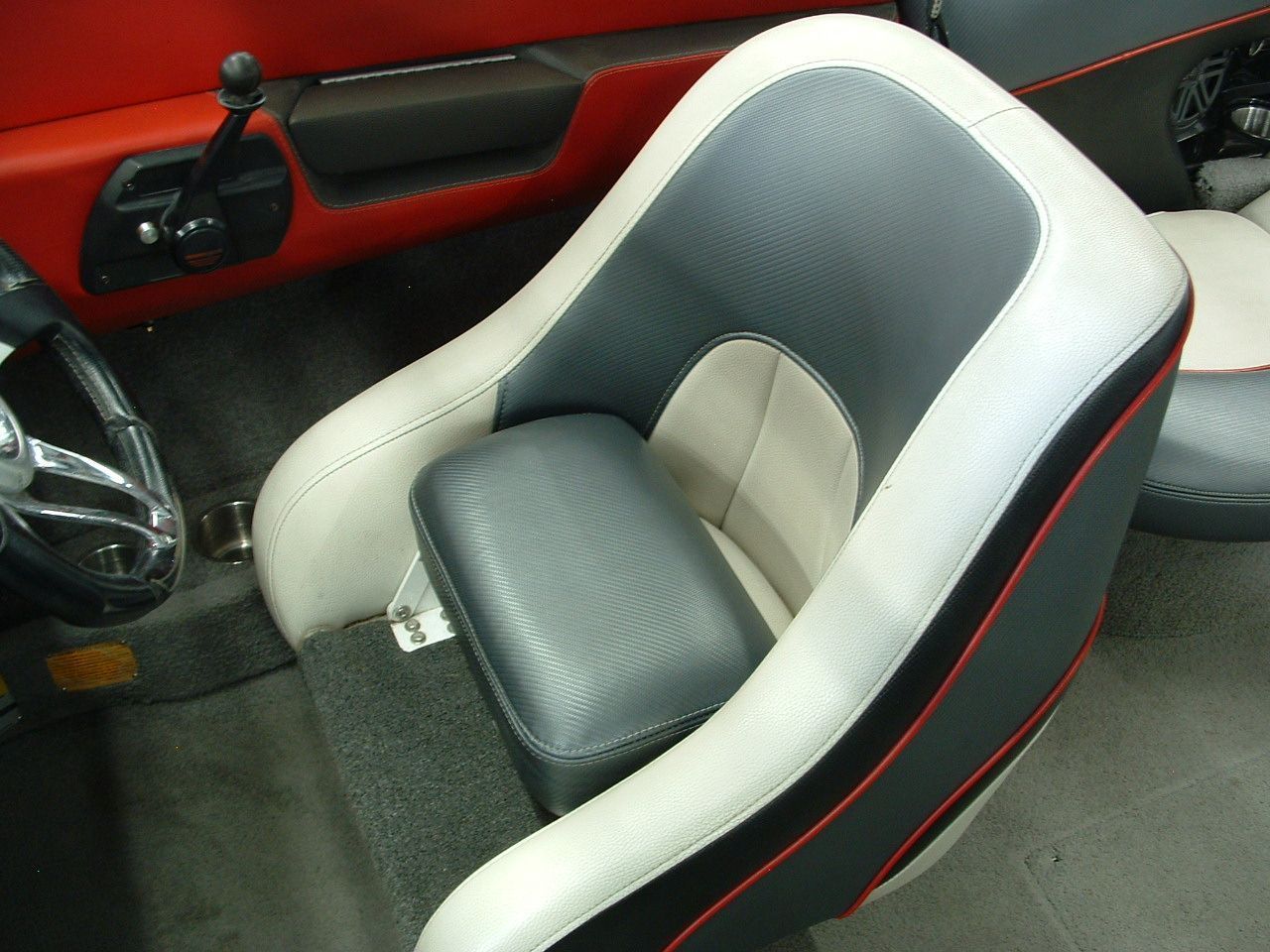 A black and white boat seat with a red trim