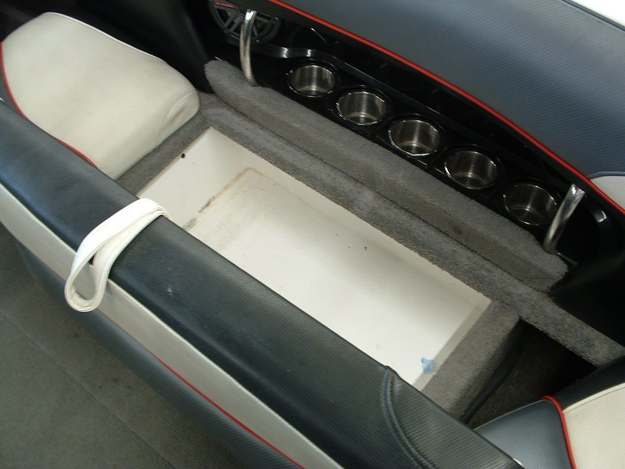 The back of a boat with a white box in it