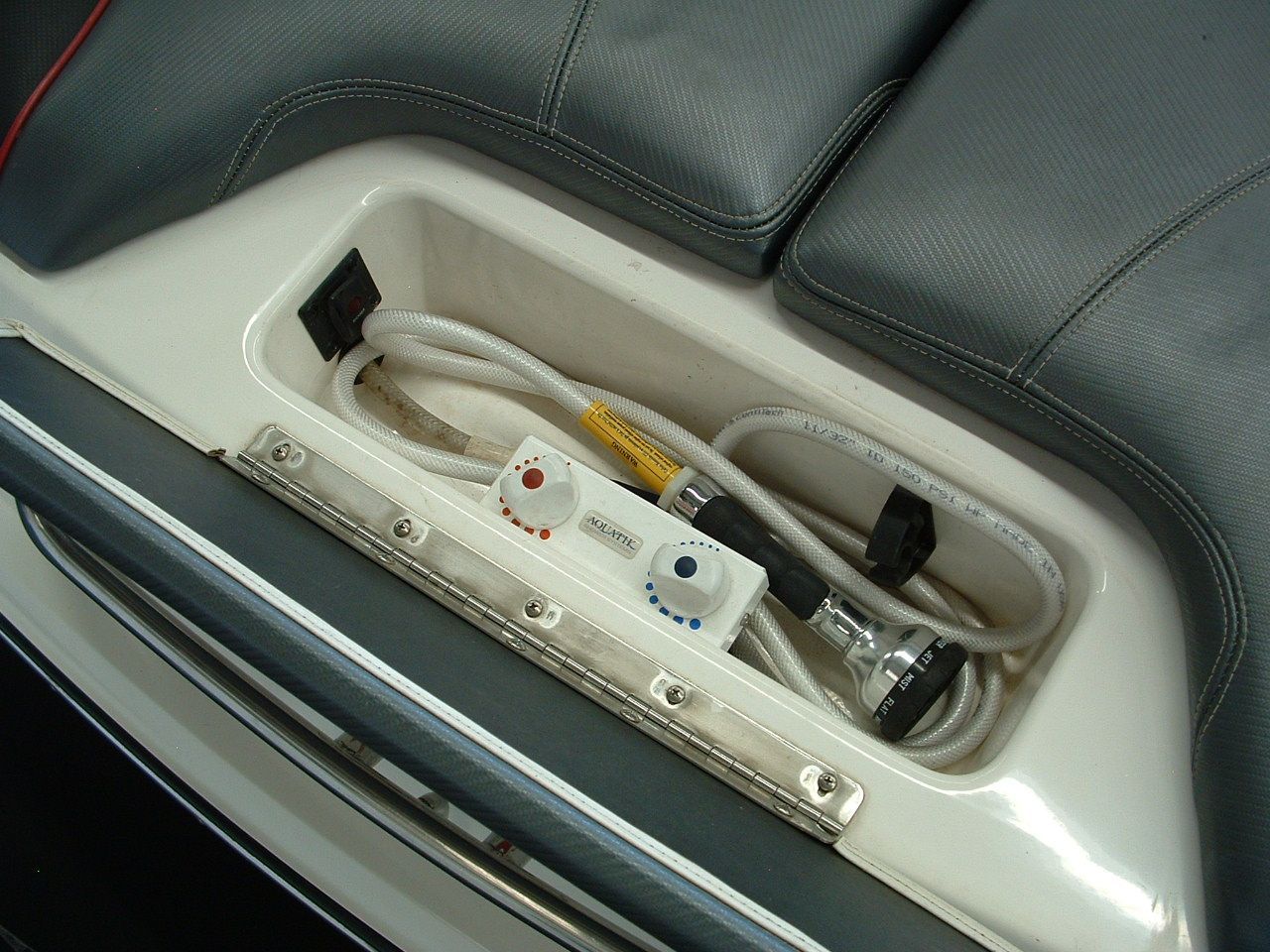 A boat with a remote control and a hose in it