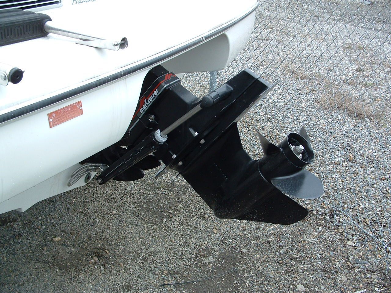 A white boat with a black outboard motor attached to it