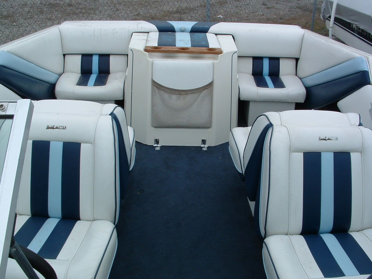 A boat with blue and white stripes on the seats