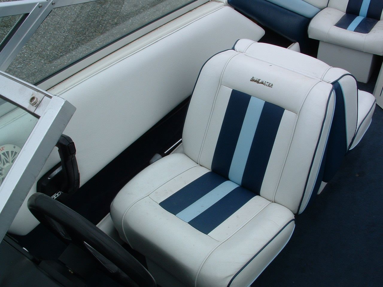 A boat with blue and white stripes on the seats