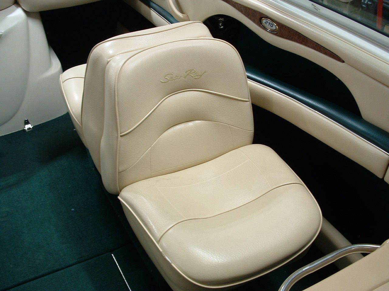 Two tan seats in a boat with a gp logo on the door