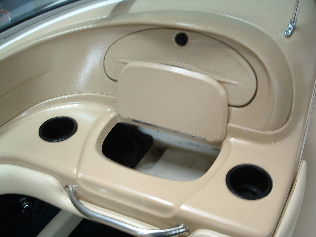 A boat with the lid open and two cup holders