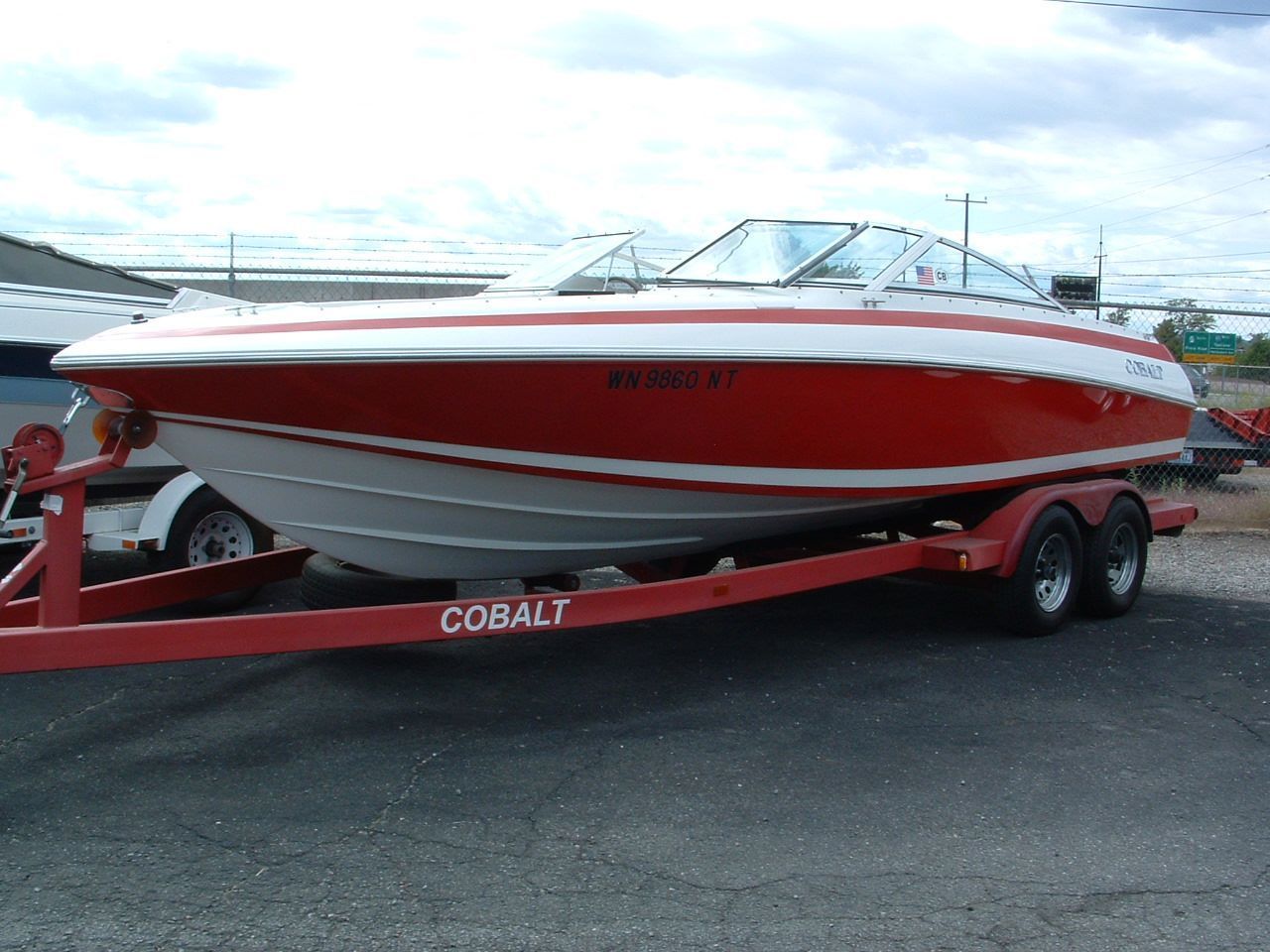 A red and white boat on a cobalt trailer