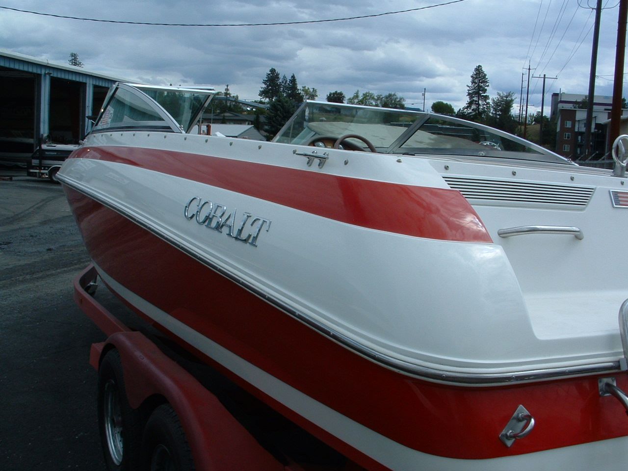 A red and white boat with the name coral on the side