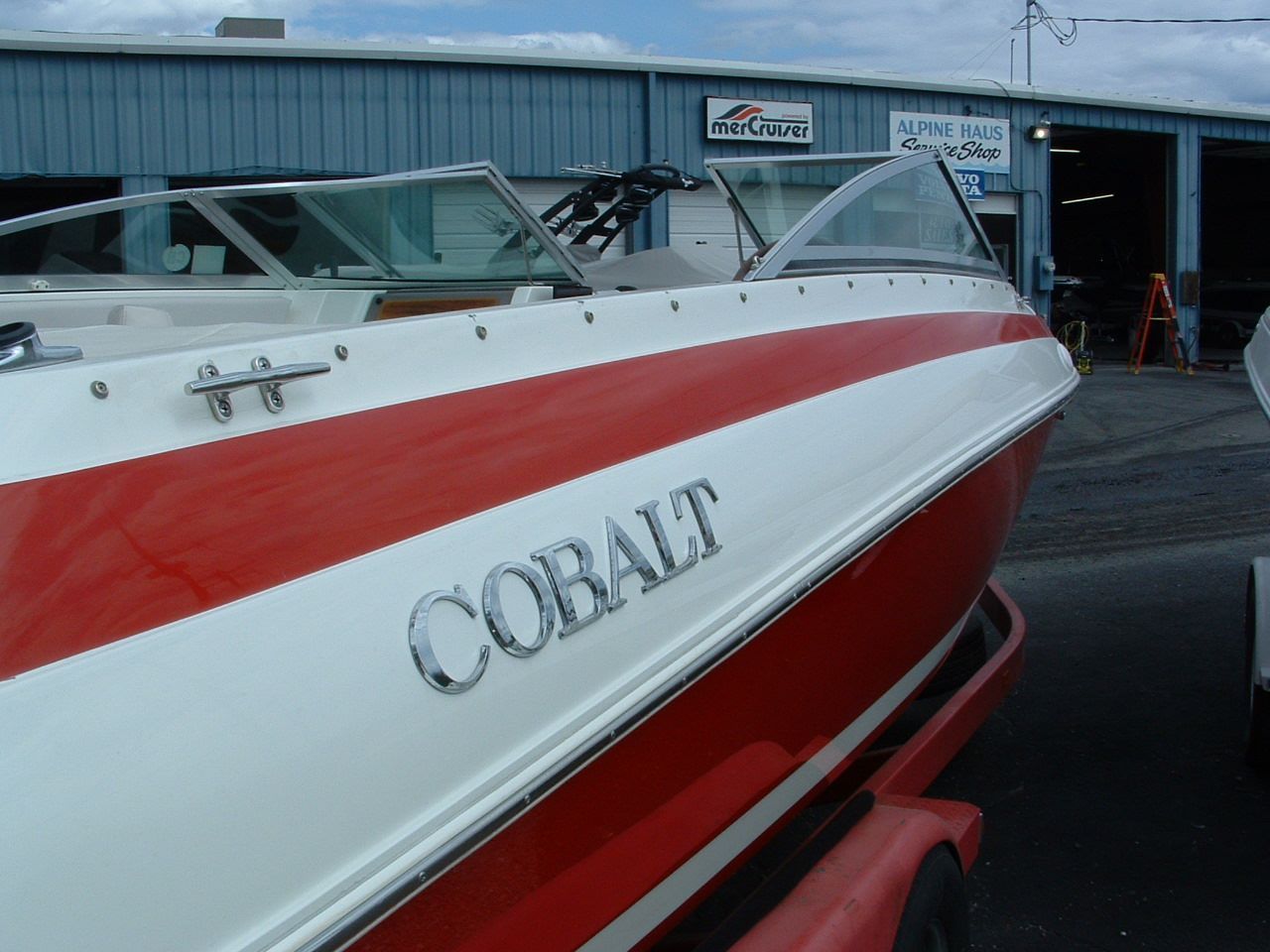 A red and white boat with the word cobalt on the side