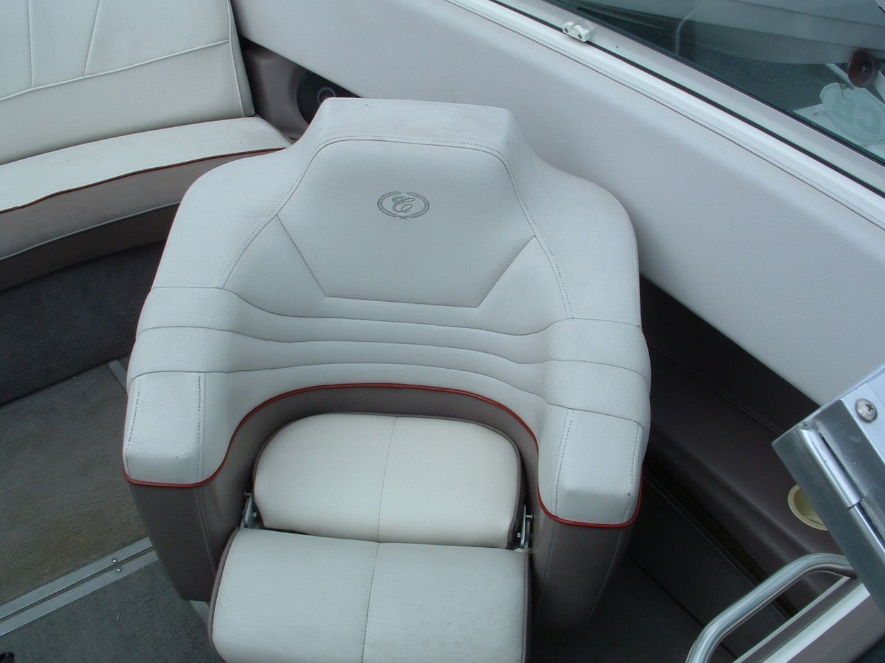 A white chair on a boat with the letter d on it