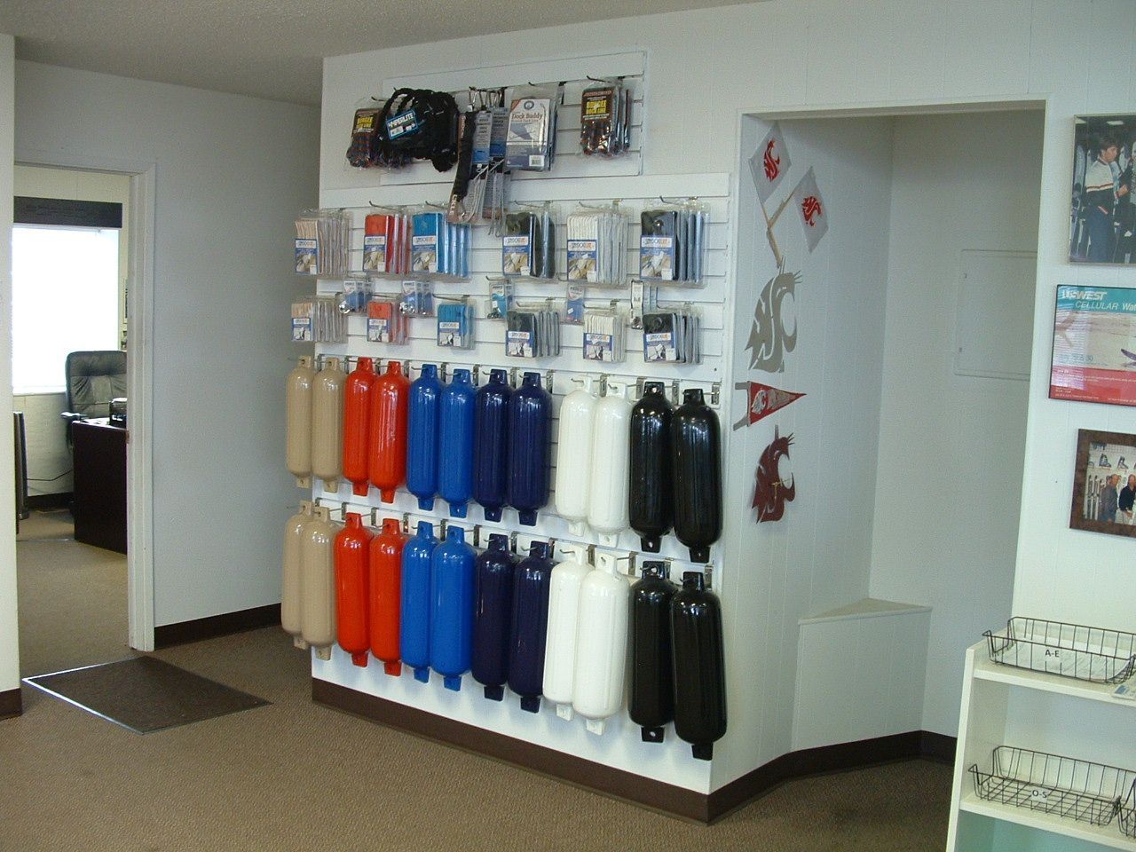 A wall with a bunch of different colored buoys on it