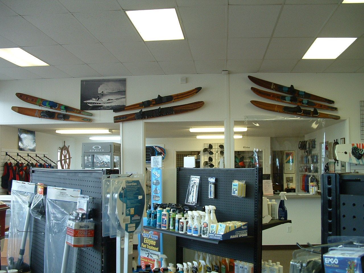 The inside of a store with skis hanging on the wall