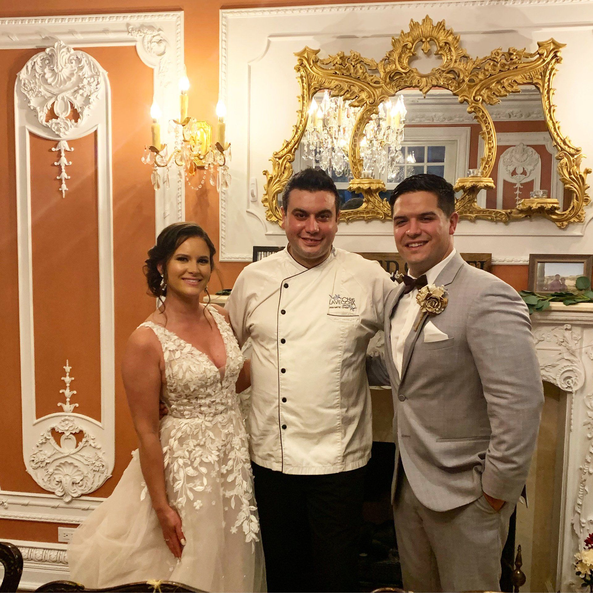 Chef posing with the bride and groom