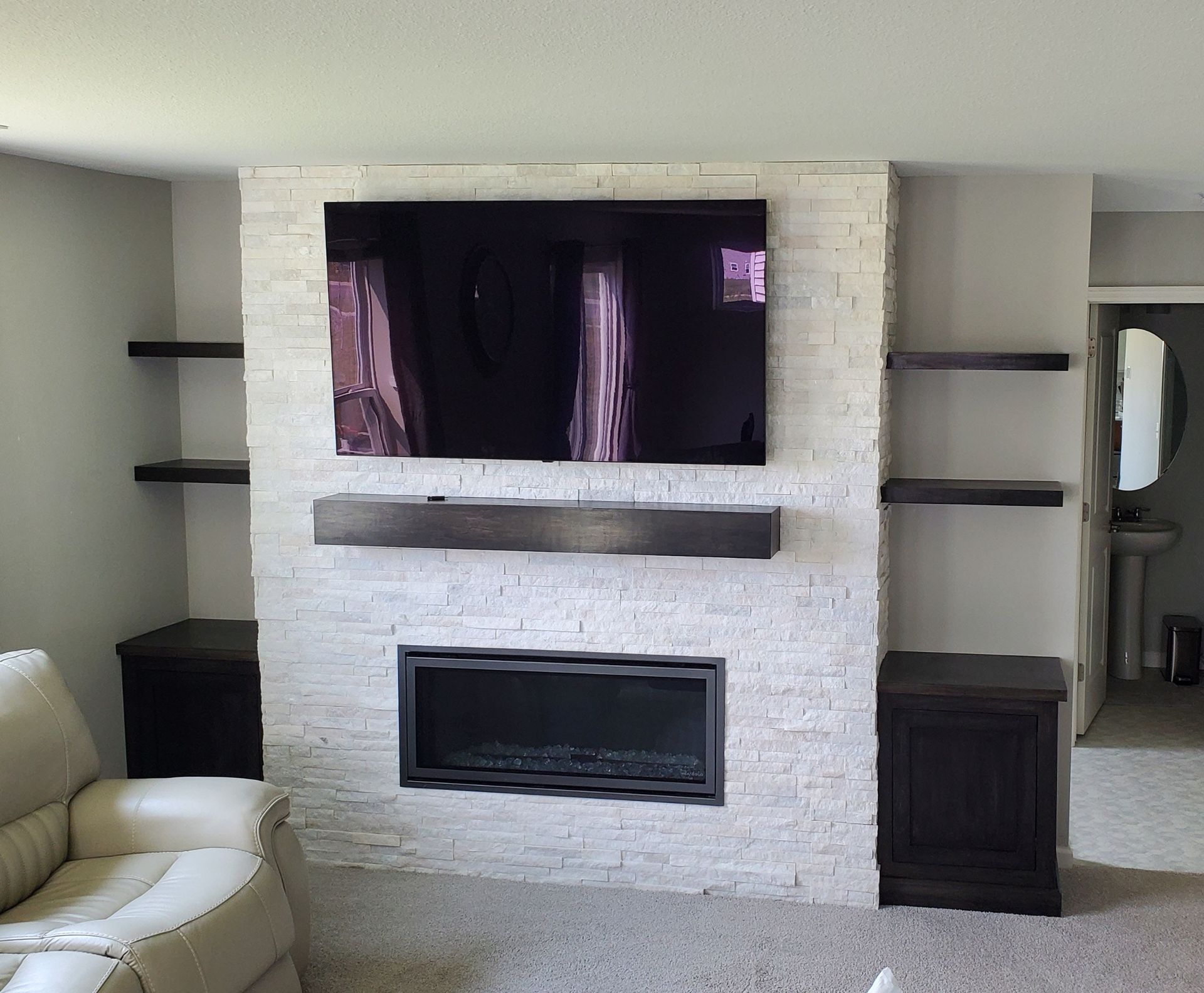 A living room with a fireplace and a flat screen tv