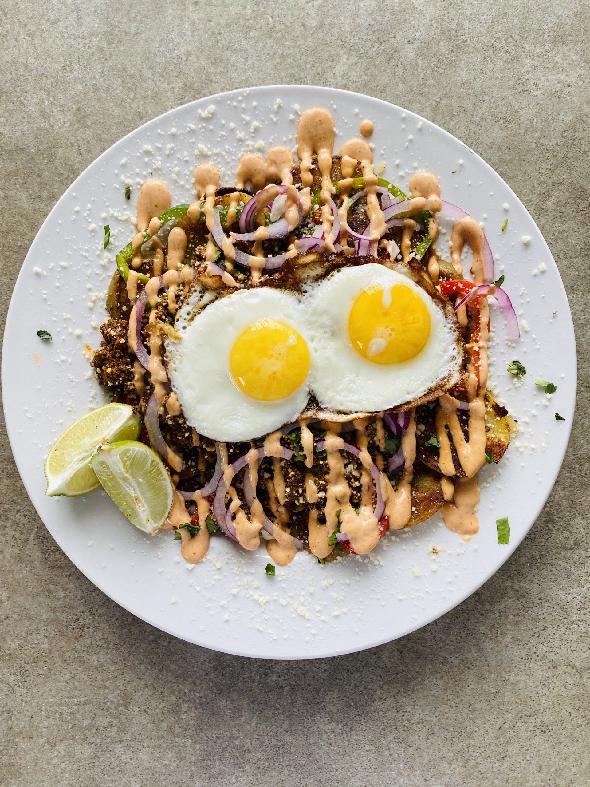 A white plate topped with eggs and vegetables on a table