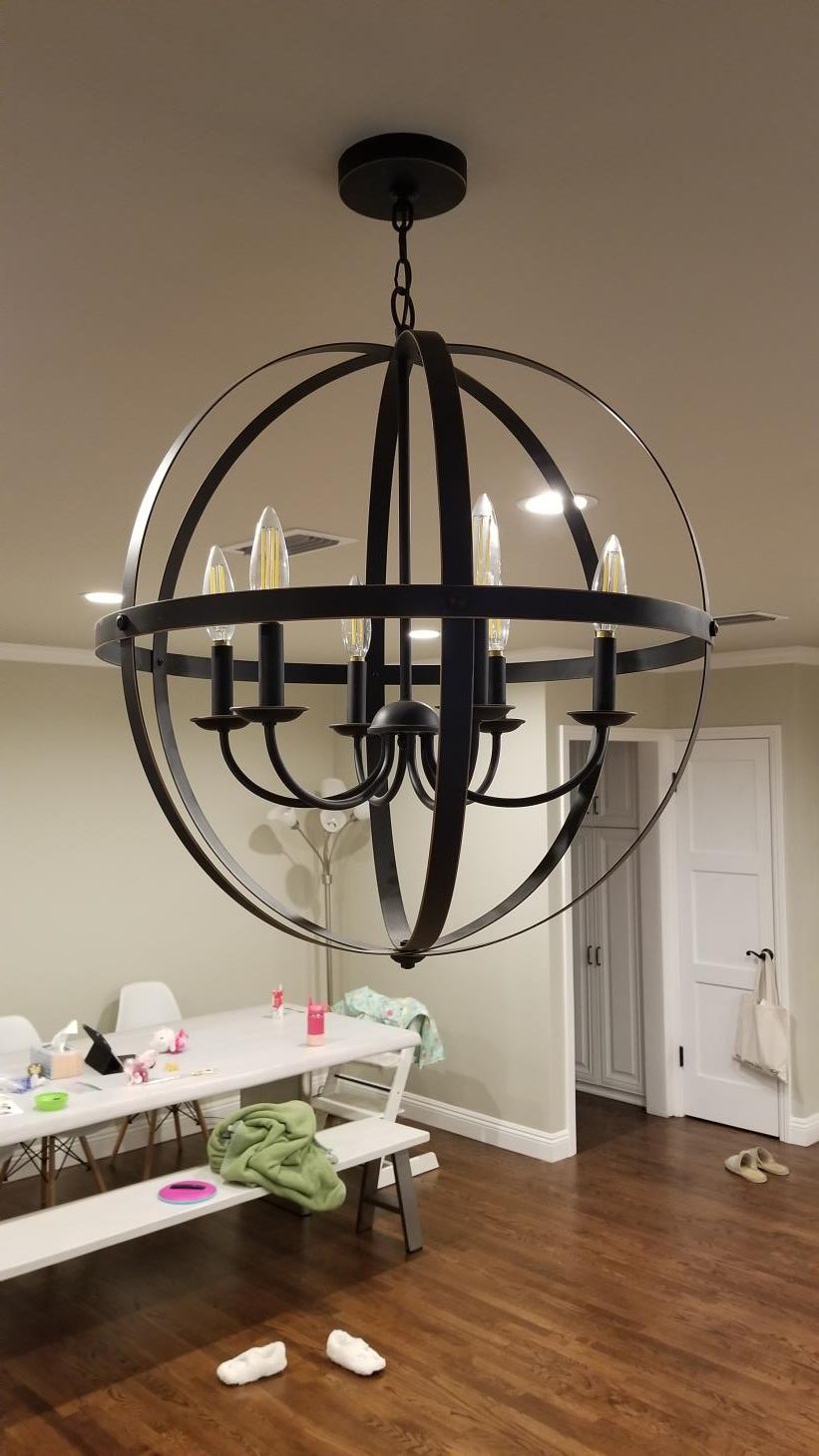 A chandelier is hanging from the ceiling in a living room.