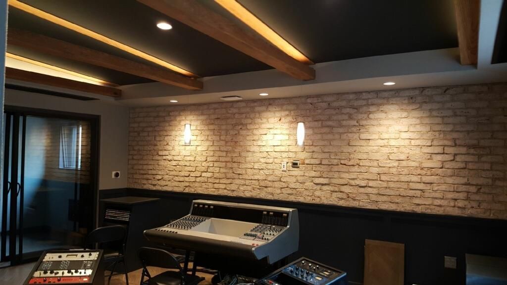 A room with a brick wall and a mixer in it.