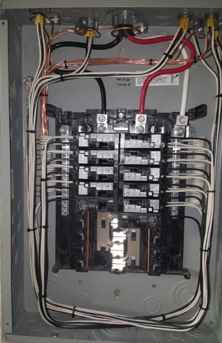 A electrical box with a lot of wires coming out of it