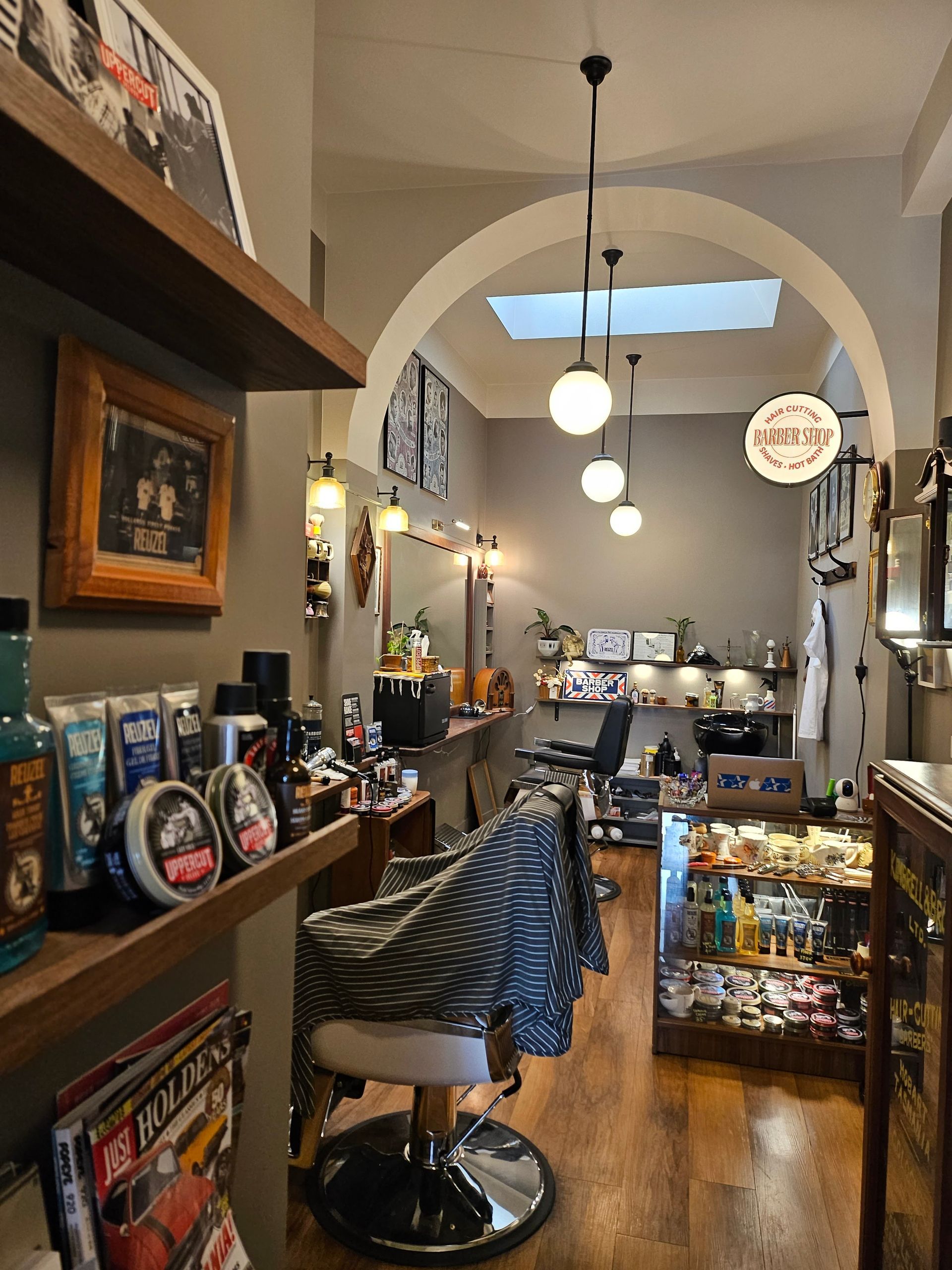 Barber Shop Interior With Hanging Lights, Wooden Shelves, and a Zebra-print Chair — Lucky Child Barber Shop In Hobart, TAS