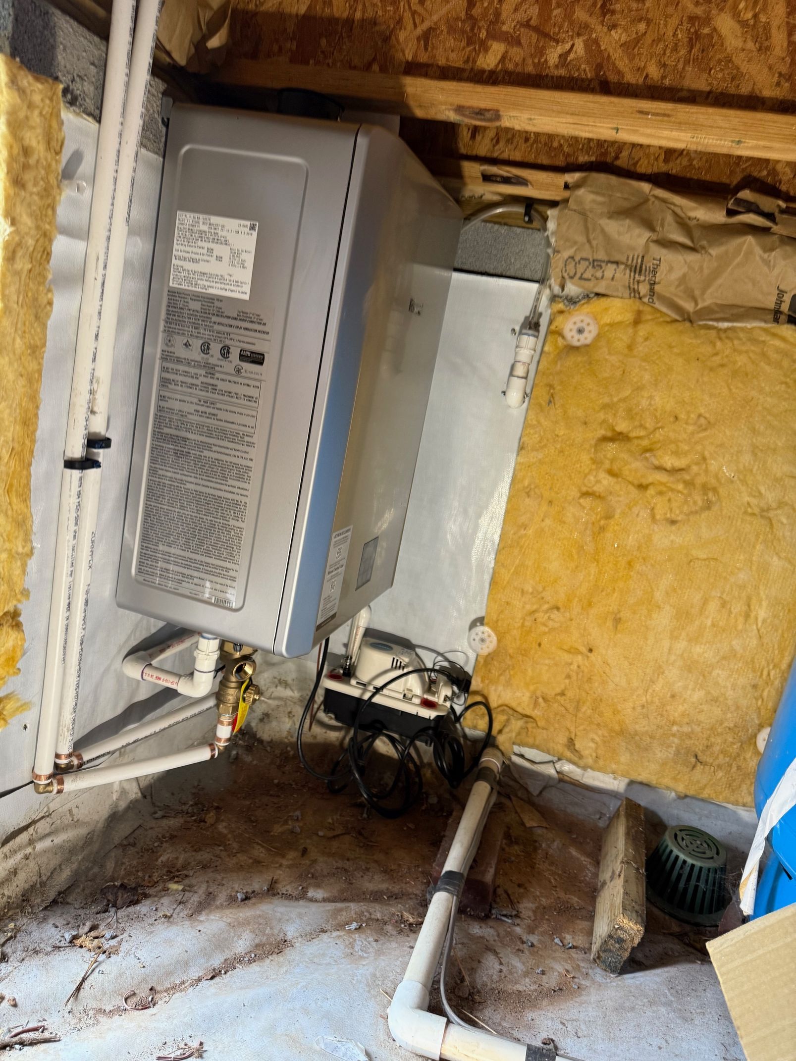 A broken refrigerator is sitting in the corner of a room.