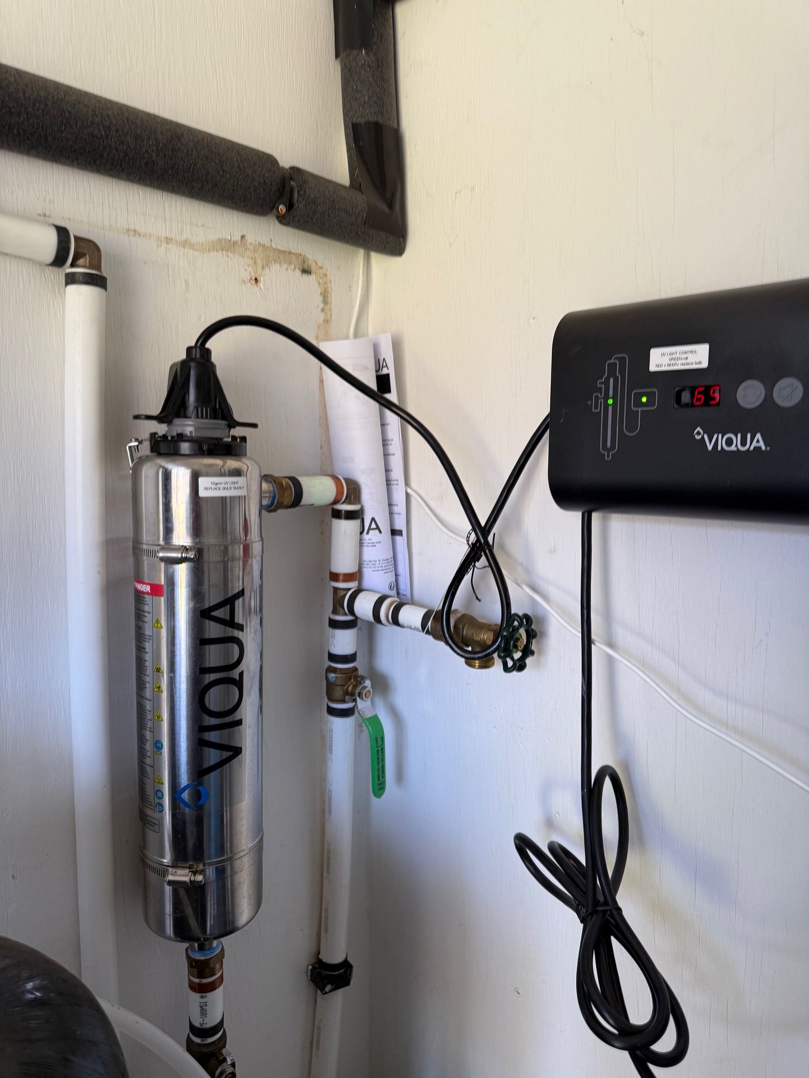 A viqua water filter is attached to a wall