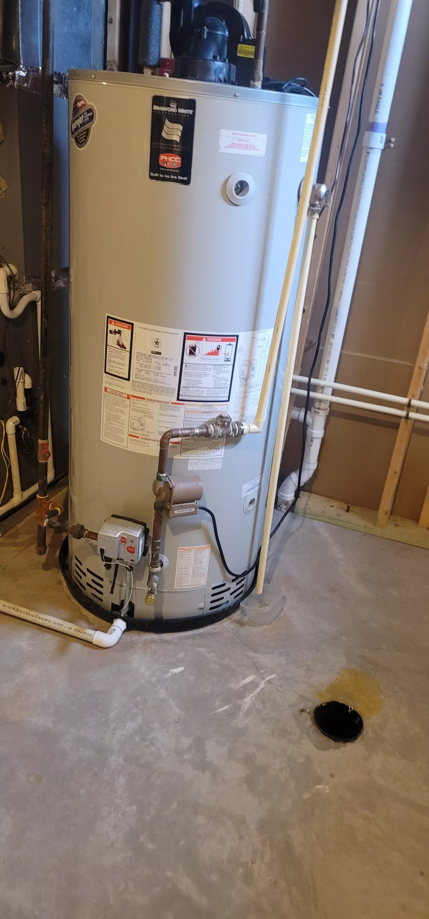 A bathroom with a pedestal sink, three-light fixture above, and a closed door.