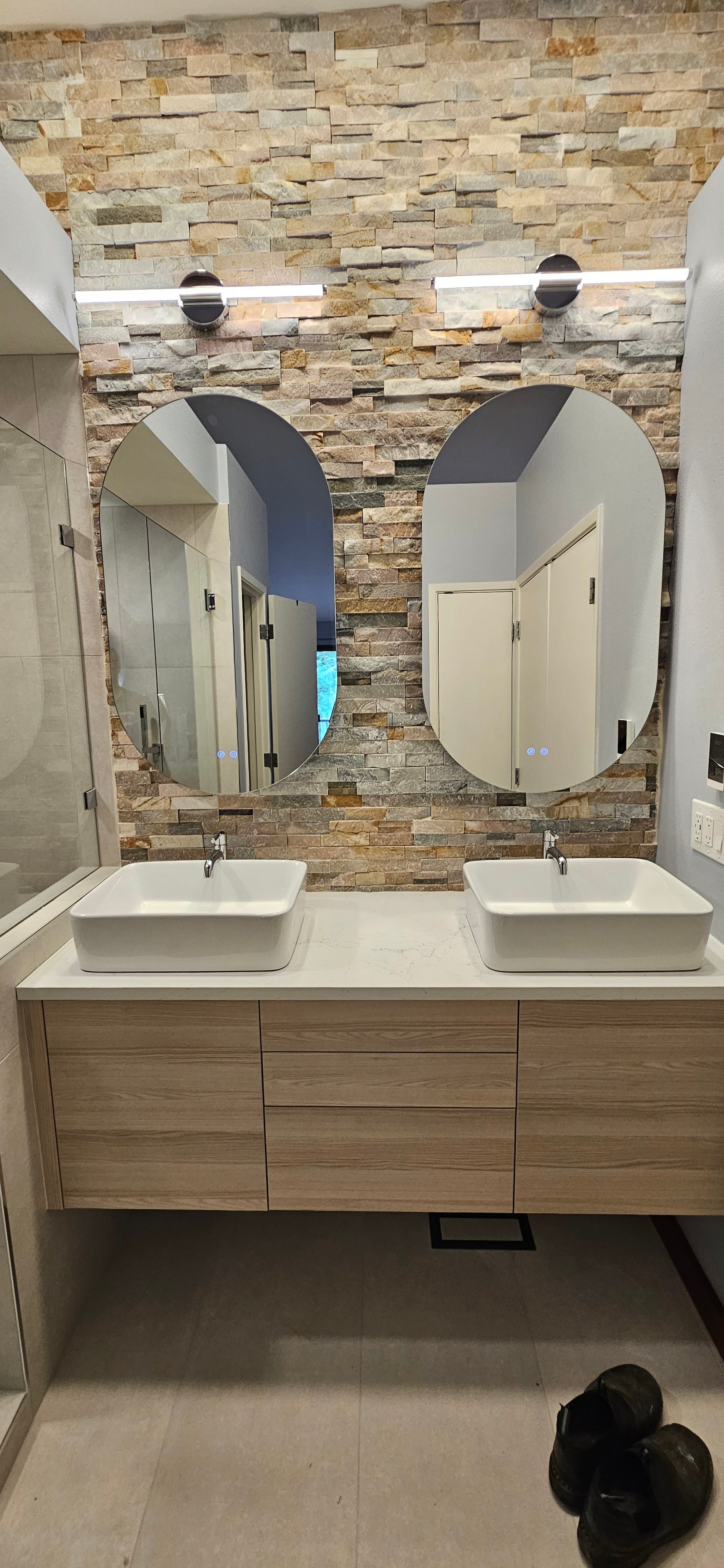 Blue water meter on a brick with a black background.