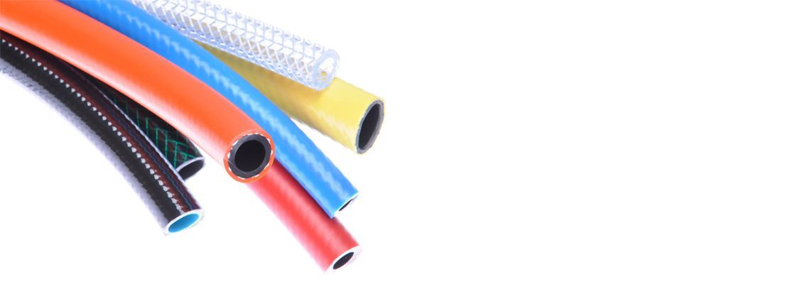 Colorful hoses of varying colors, close up.