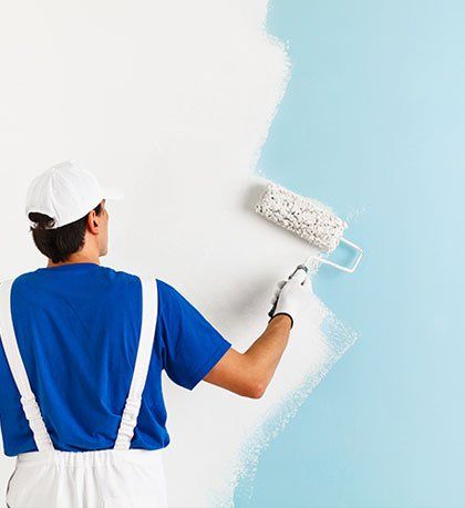 Wall Painting — Painting a Wall with Paint Roller in Seattle, Washington