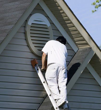 Roof Painting — Painter Working at Roofline in Seattle, Washington