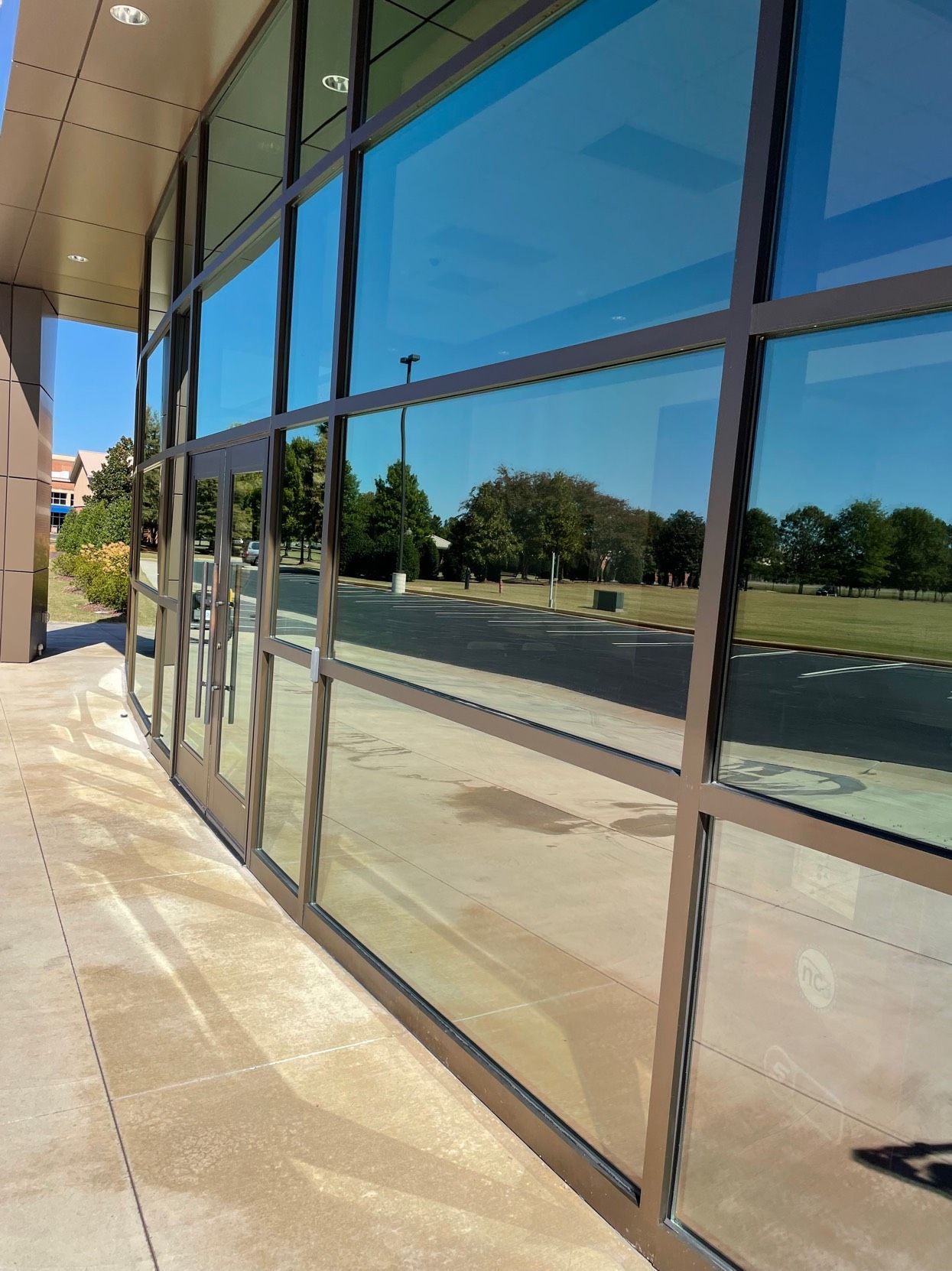 A large house with a large porch and a blue sky in the background
