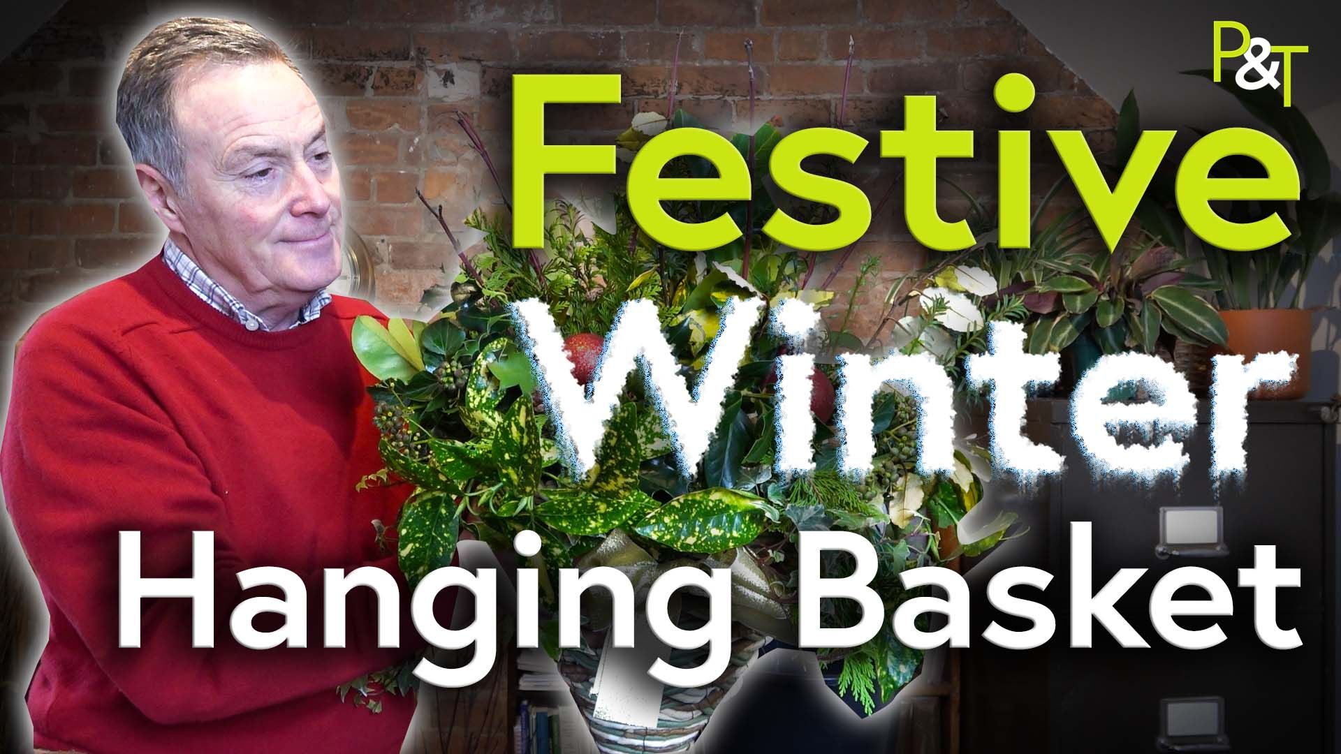 Martin Fish wearing a red jumper on left of frame and holding a hanging basket he's just arranged wintery foliage such as ivy, holly, yew and some baubles and pine cones. The text