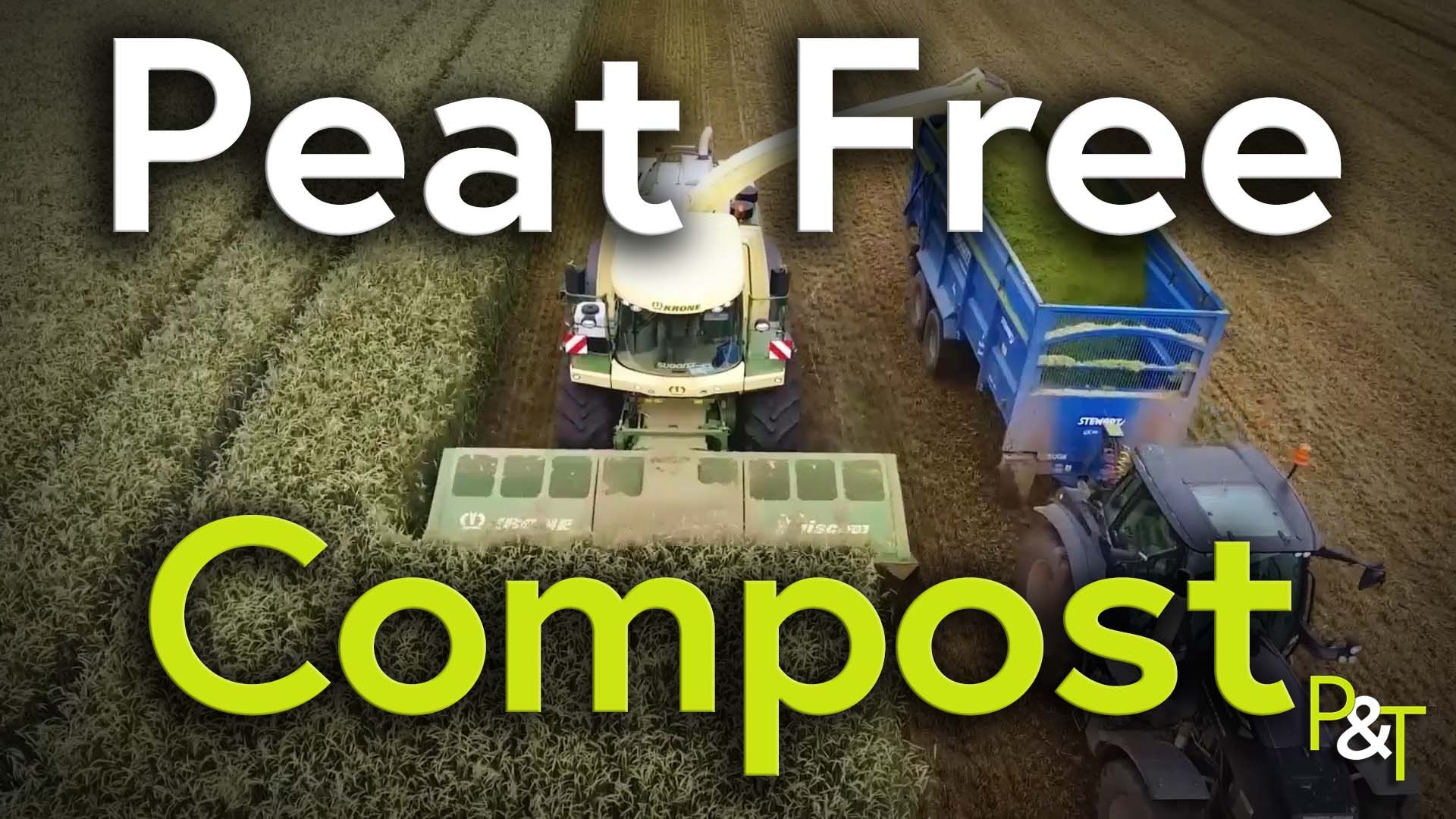 Overhead shot of a combine harvester in a field with a blue trailer collecting the clippings
